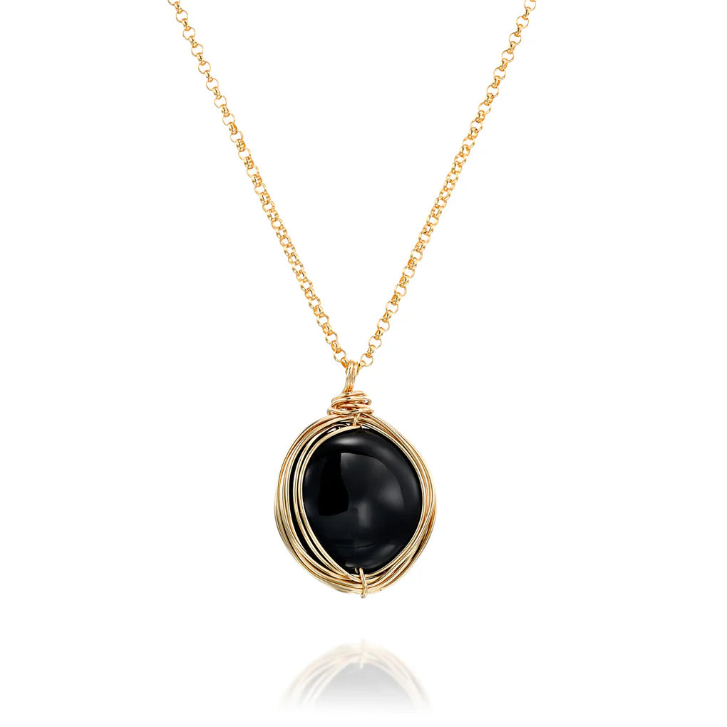 Universe Coin Onyx Necklace featuring a natural coin-shaped black onyx set in a gold-filled spiral pendant