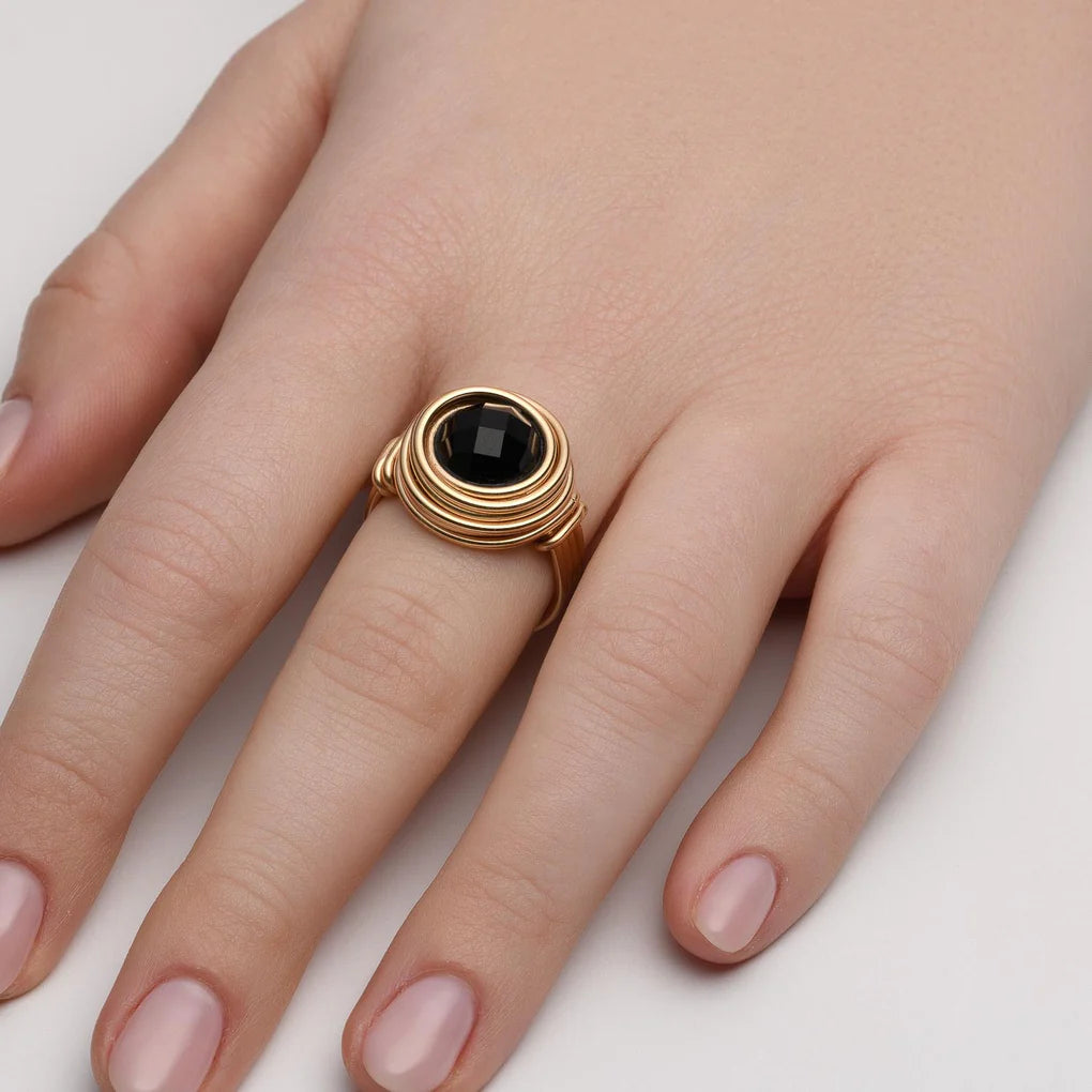 Universe Onyx Ring featuring a large faceted black onyx stone set in high-quality gold-filled spirals