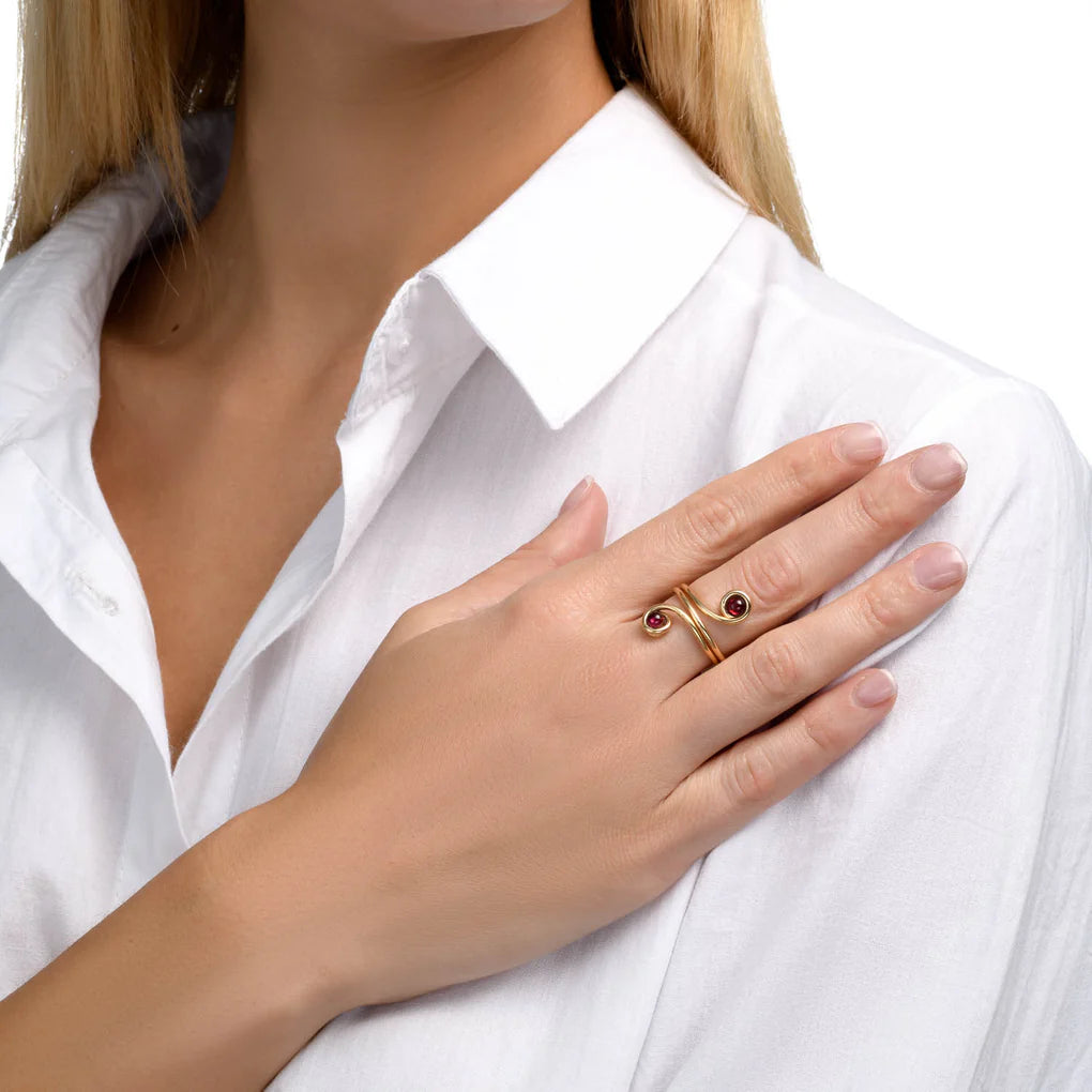 Universe Swirl Garnet Ring featuring two natural garnet stones set in flowing gold-filled spiral design