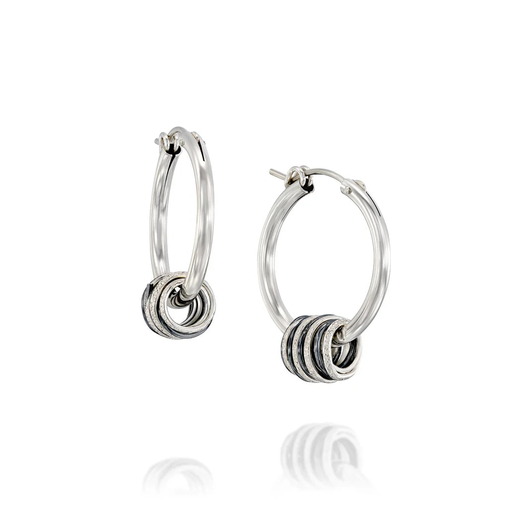 Rolling hoop earrings with silver and blackened 999 silver swirls, handcrafted design.