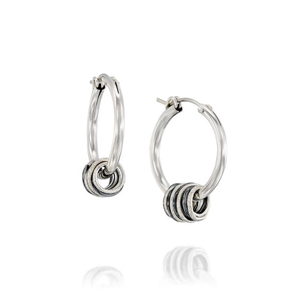 Rolling hoop earrings with silver and blackened 999 silver swirls, handcrafted design.