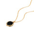 Universe Coin Onyx Necklace featuring a natural coin-shaped black onyx set in a gold-filled spiral pendant