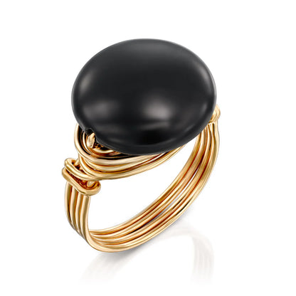 Universe Coin Onyx Ring featuring a natural coin-shaped black onyx stone set in layered gold-filled spirals