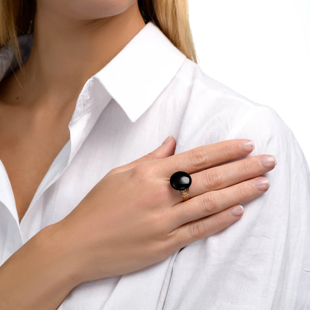 Universe Coin Onyx Ring featuring a natural coin-shaped black onyx stone set in layered gold-filled spirals