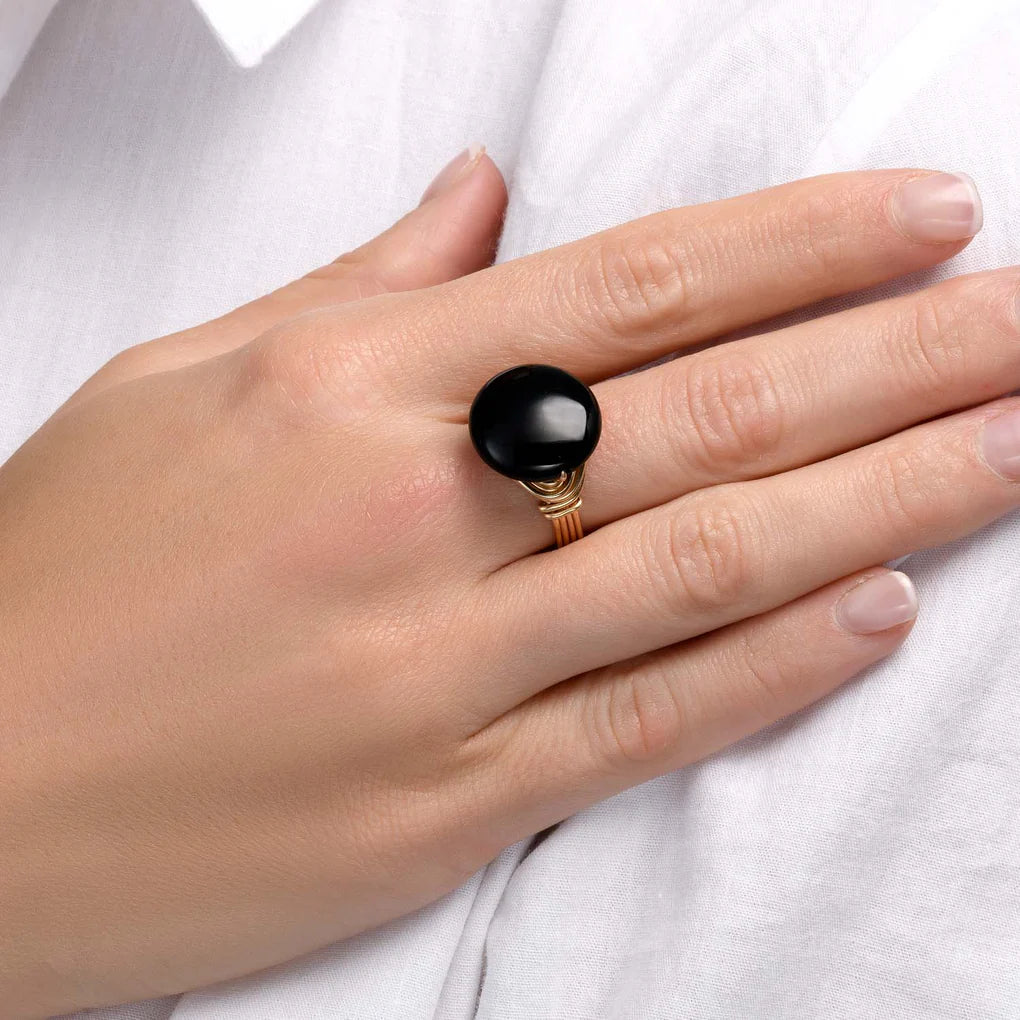 Universe Coin Onyx Ring featuring a natural coin-shaped black onyx stone set in layered gold-filled spirals